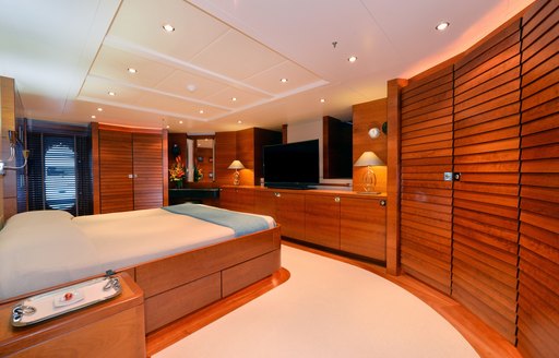 large bed in the centre of the master suite aboard expedition yacht BELUGA