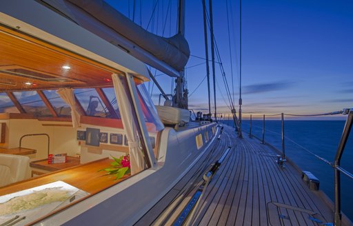 view of side decks and helm as the sun sets as charter yacht JUPITER anchors in the Caribbean 