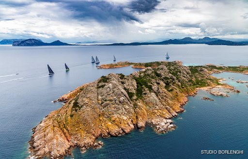 La Maddalena archipelago with sailing yachts rounding the corner in Porto Cervo