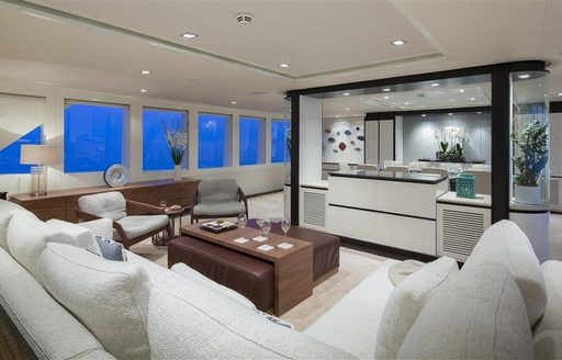 main salon with white sofas on board motor yacht AUSTRALIS