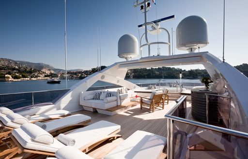 sun loungers, seating and bar on sundeck of charter yacht THUMPER 