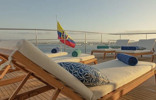Sun loungers with towels ste up on the deck of charter yacht KONTIKI WAYRA