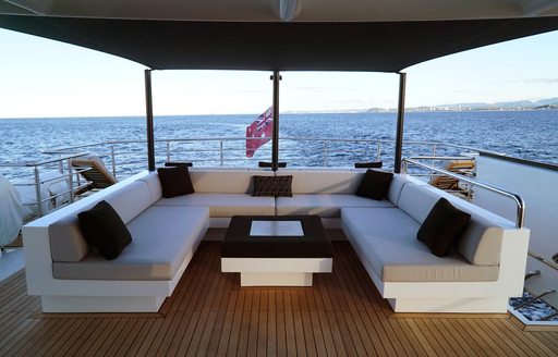 U-shaped sofa and coffee table on sundeck of superyacht SAHANA 