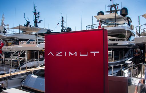 Large, red Azimut sign on display in front of superyachts berthed at the Monaco Yacht Show