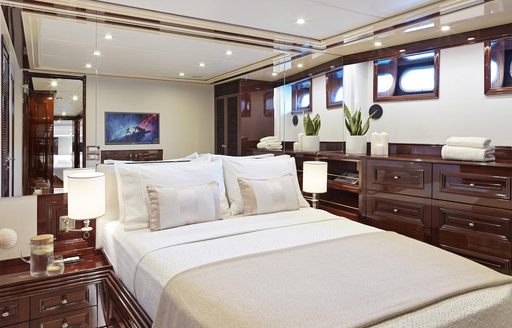 Spacious charter guest cabin onboard charter yacht Mia Zoi, central berth facing forward with storage to port and starboard