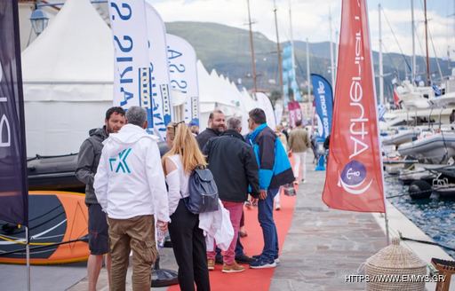 Visitors at the East Med Multihull & Yacht Charter Show in discussion on a red carpet adjacent to exhibitor tents