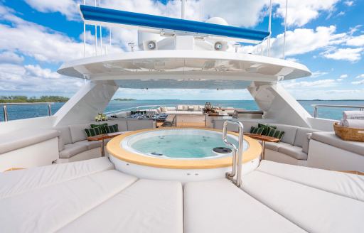 On deck Jacuzzi onboard charter yacht ZEXPLORER, surrounded by sun pads and views of the sea