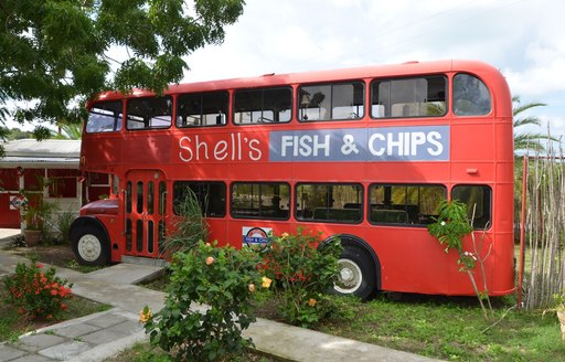 red double decker london bus housing Shell's fish and chips Antigua