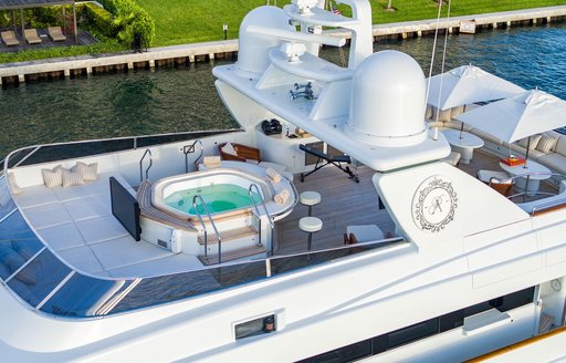 Sun deck onboard charter yacht ARTEMISEA, large Jacuzzi with sun pads and large exterior cinema screen