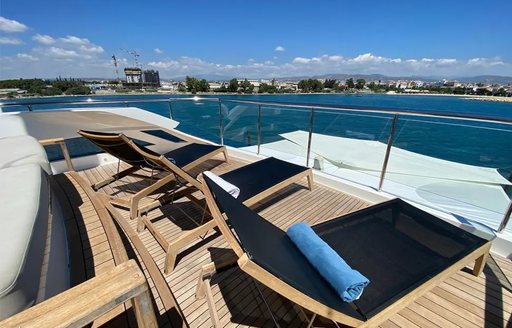 Sun loungers on the top deck onboard charter yacht LE VERSEAU
