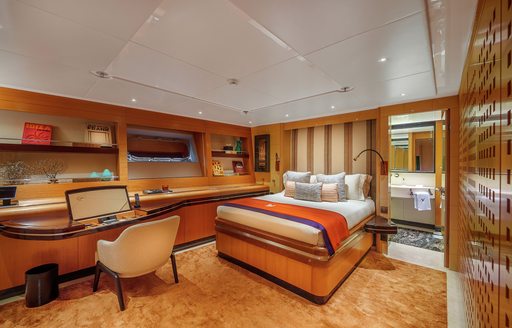Double guest cabin onboard sailing yacht charter MALTESE FALCON, central berth facing forward with access to en-suite aft and a dressing table in the foreground