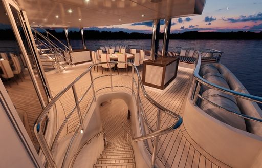 circular alfresco dining table on upper deck aft of charter yacht AXIOMA 