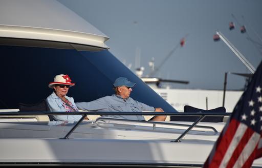 an elderly couple sitting on the foredeck of a luxury superyacht at the 2020 miami yacht show