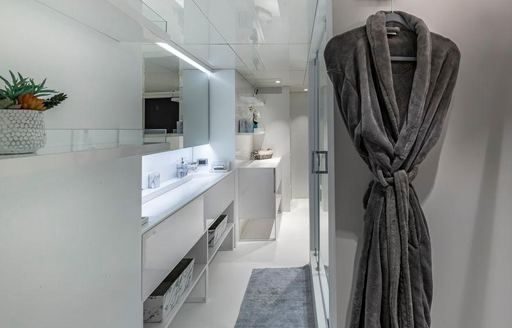 Robe hanging outside door into ensuite on superyacht OCULUS