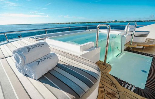 Deck Jacuzzi and sun pads onboard charter yacht BABAS