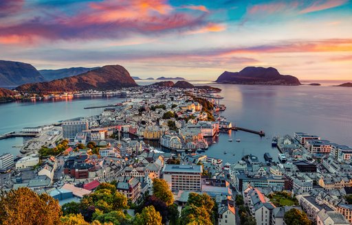 town of alesund with sunset in background
