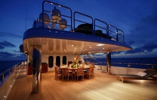 alfresco dining on the bridge deck aft at night on board charter yacht ‘Top Five’ 
