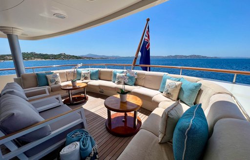 Overview of the alfresco lounge area on the aft main deck of charter yacht SOLAFIDE