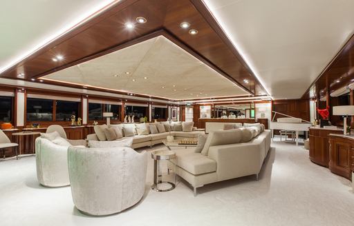 Salon area with grand piano on board luxury charter yacht O'MEGA