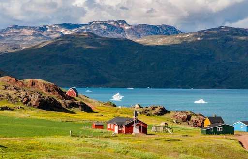 picturesque landscape, red house and blue waters in Greenland