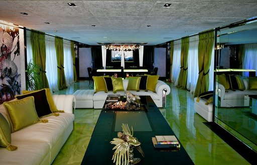 Main salon onboard charter yacht SARASTAR, spacious lounge area with green aesthetics