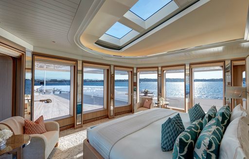 Master cabin onboard charter yacht JOY, with central berth and multiple surrounding windows