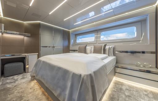 Cabin onboard superyacht NO STRESS TWO, central berth underneath a wide window.