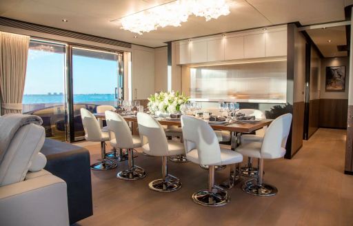 Interior dining set up in the main salon onboard charter yacht FREEDOM