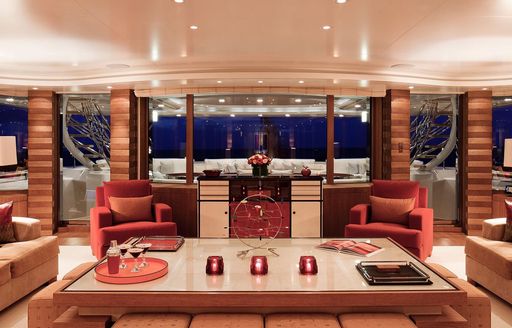 Elegant interior of charter yacht Lady E with comfortable chairs and large table in foreground