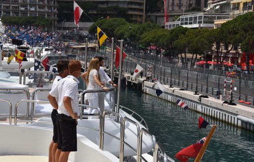 Spectators on board yachts watch Formula one cars racing at the Monaco Grand Prix