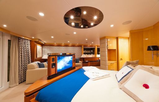 large bed and TV in full-beam master suite on board luxury yacht SPIRIT 