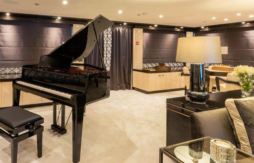 glamorous skylounge with black grand piano aboard charter yacht ELIXIR 