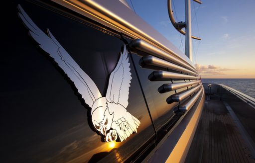 logo on side deck of sailing yacht ‘Maltese Falcon’ as sun sets over the horizon