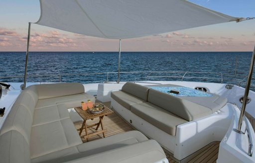 large and sumptuous deck seating on luxury charter yacht hot pursuit