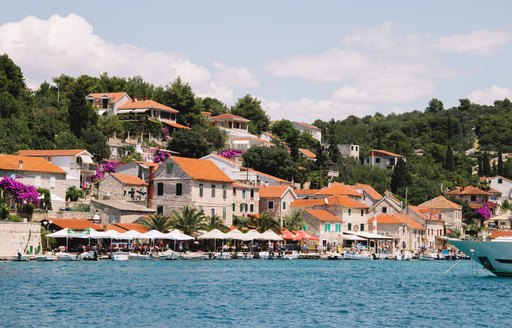 Town of Maslinica in croatia, beautiful stone cobbled buildings overlooking the water 