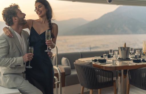 Man and woman enjoy cocktails on board charter yacht VIVALDI
