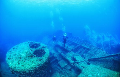 Scuba divers examine a wreck in Greece