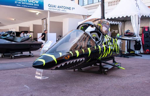 Close up view of a personal craft at the Monaco Yacht Show with a painted mural of a shark on the craft exterior.