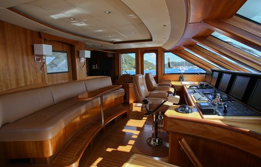 Wood panelled cockpit on M with a bench behind with neutral fabrics
