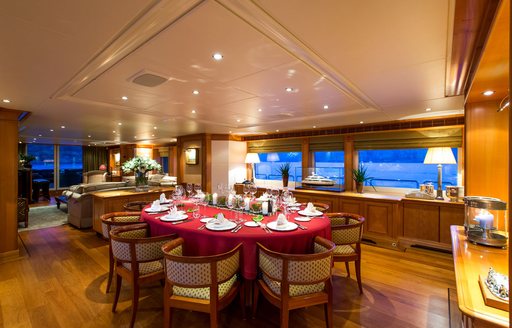 dining table and chairs in main salon of luxury yacht ‘Seven Sins’ 