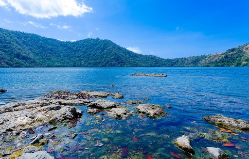 calm waters of Komodo with rain-forest covered mountains in Indonesia