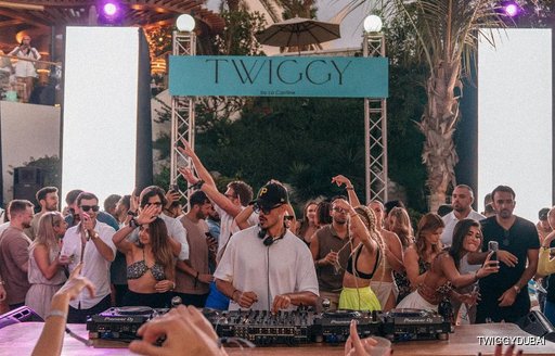 DJ at Twiggy Dubai with many people dancing around him