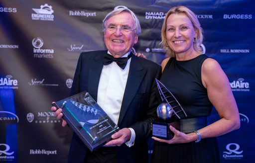 Man and woman representing AHPO hold ISS awards