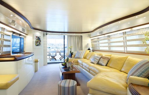 light and airy main salon with large yellow sofa aboard superyacht ‘Cento by Excalibur’ 