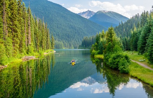 Man canoeing in picturesque calm waters of British Columbia region