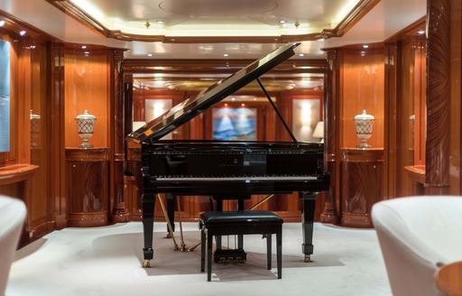 A grand piano onboard charter yacht JOIA THE CROWN JEWEL