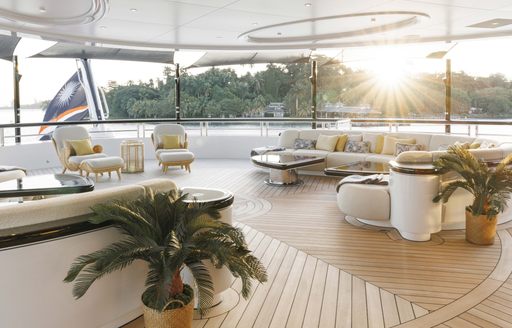 Alfresco lounge area onboard charter yacht AHPO, seating arranged around the deck with sweeping views