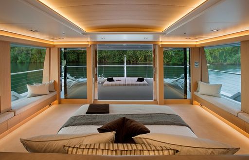 bed with stunning panoramic views forward in master suite on board charter yacht ‘Big Fish’ 