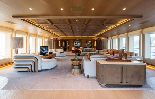 The gold ceiling and contemporary furnishings on the owner's deck of luxury yacht Here Comes The Sun