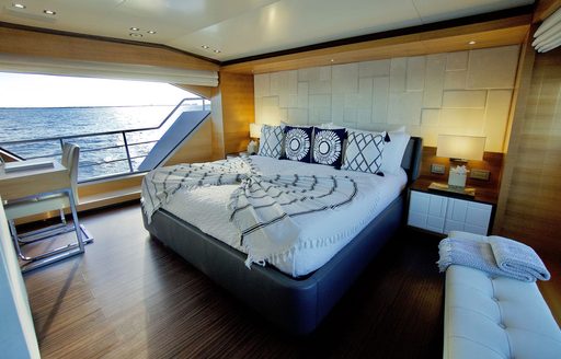 Overview of the master cabin onboard charter yacht Cool Breeze, central berth with huge window to port side.
